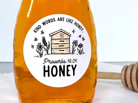 Honey Bottle with Custom Bee Garden Honey Labels on the front. The artwork shows a hand drawn apiary with wildflowers and honey bees with custom printed text for beekeepers. Personalized honey label prints with your own custom text, such as Proverbs 16: 24, Kind Words Are Like Honey. | CanningCrafts.com