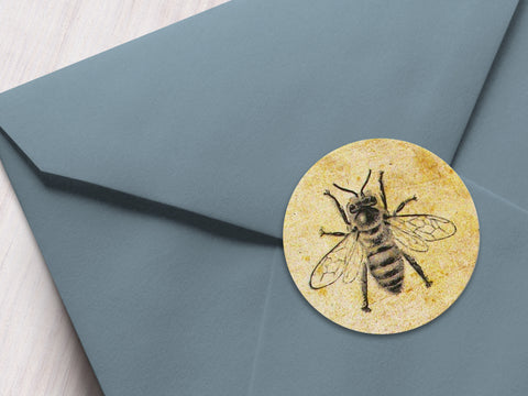 Round printed vintage honey bee labels with antique parchment paper background on a grey envelope | CanningCrafts.com